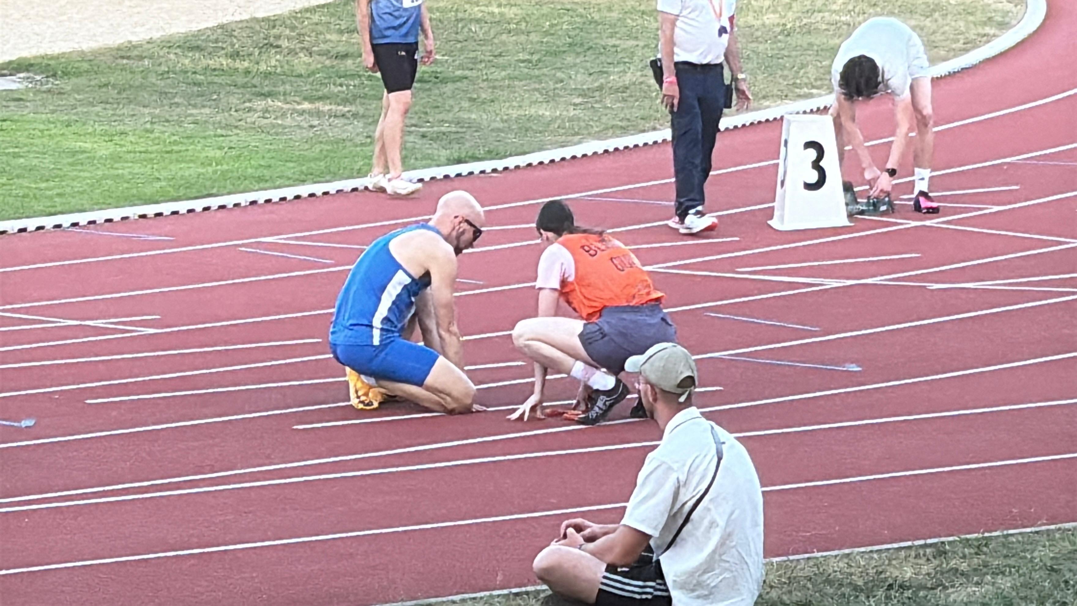 Stefan and guide Sophie in the starting blocks in lane 3, just before the start.